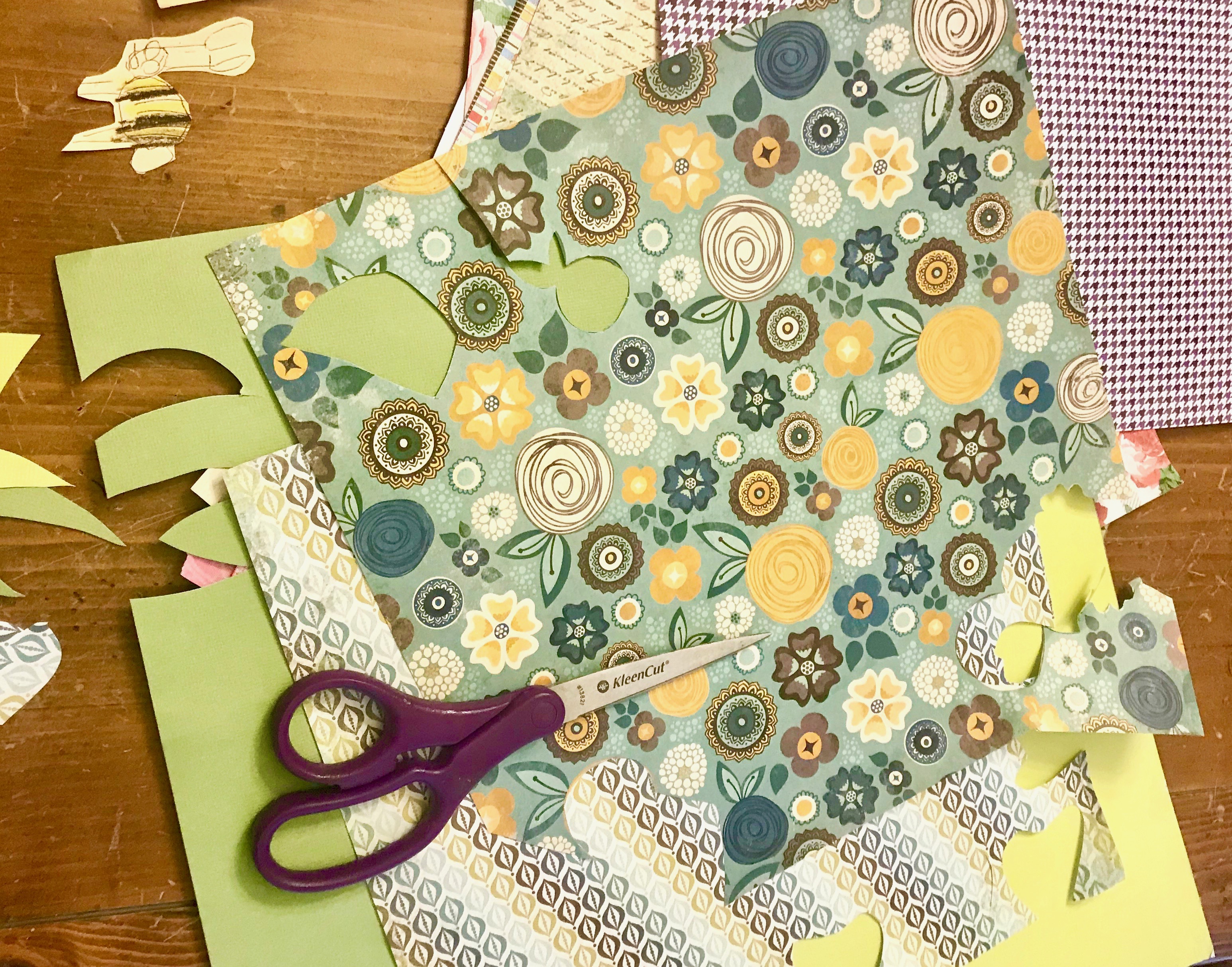 scissors on top of patterned scrapbook papers