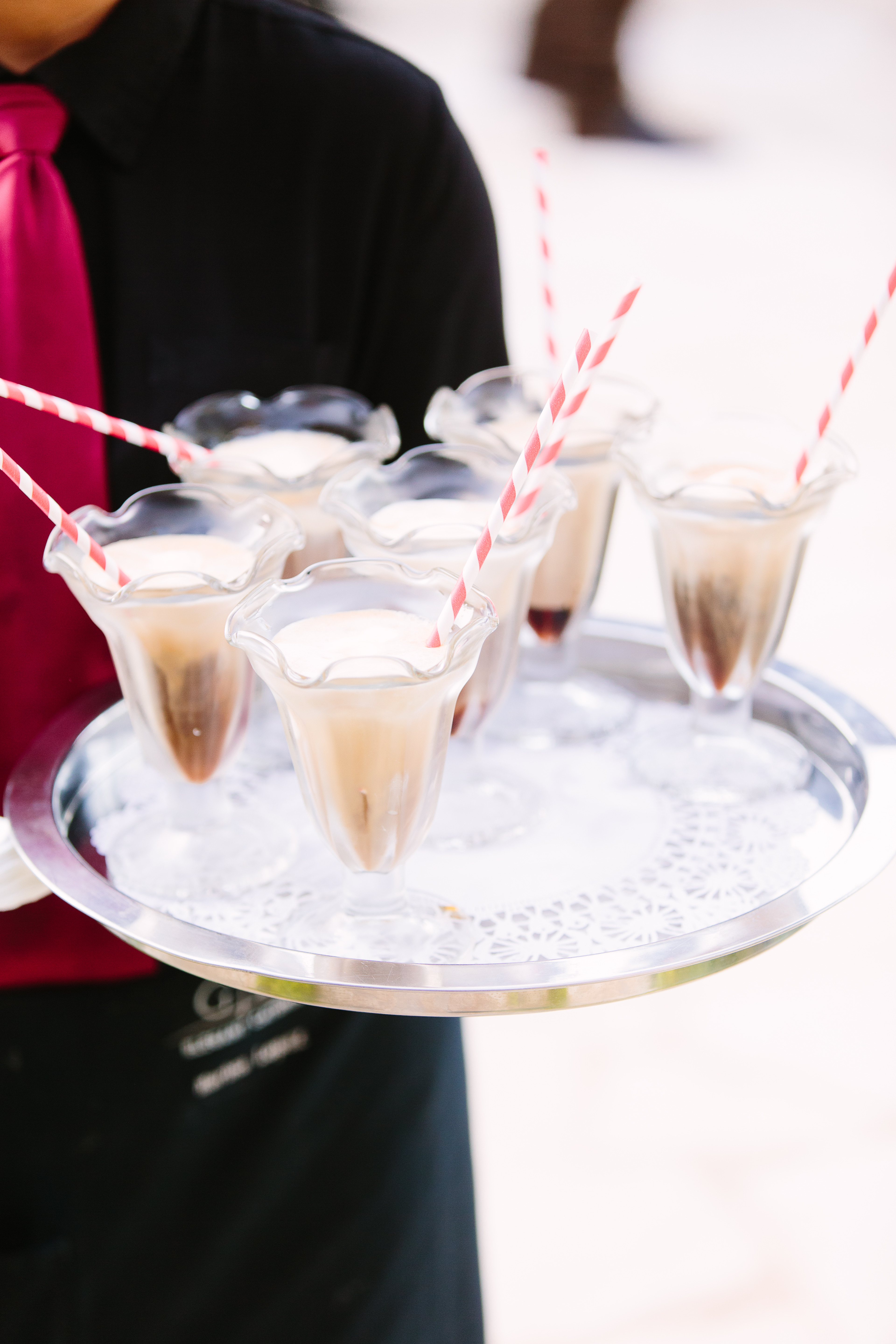 Chocolate stout floats in sundae glasses on a server's platter