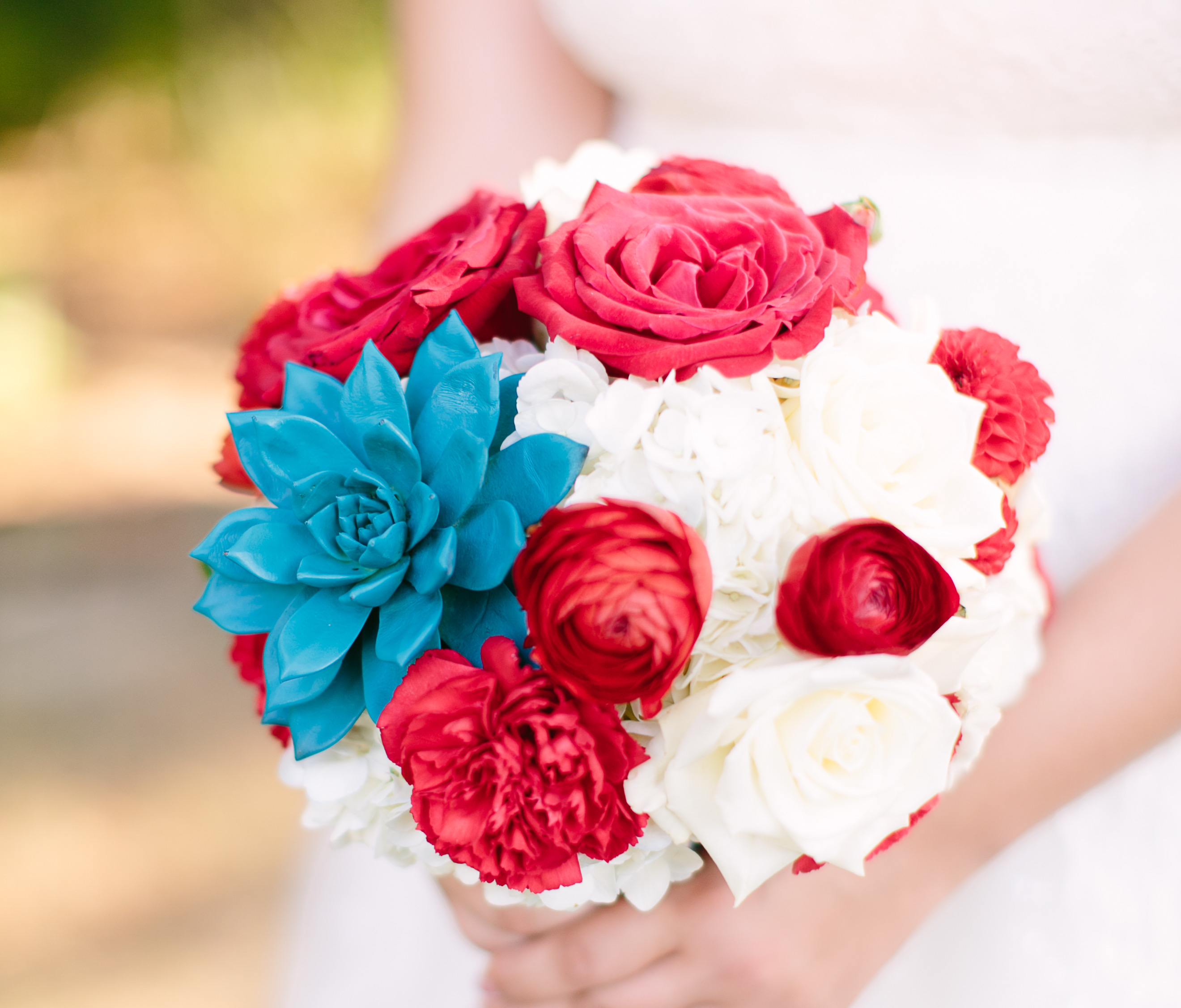 Red, white, and teal succulent wedding bouquet.