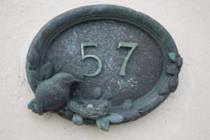A house number with bird decor