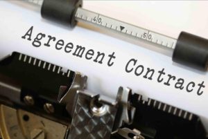 an agreement contract in a typewriter