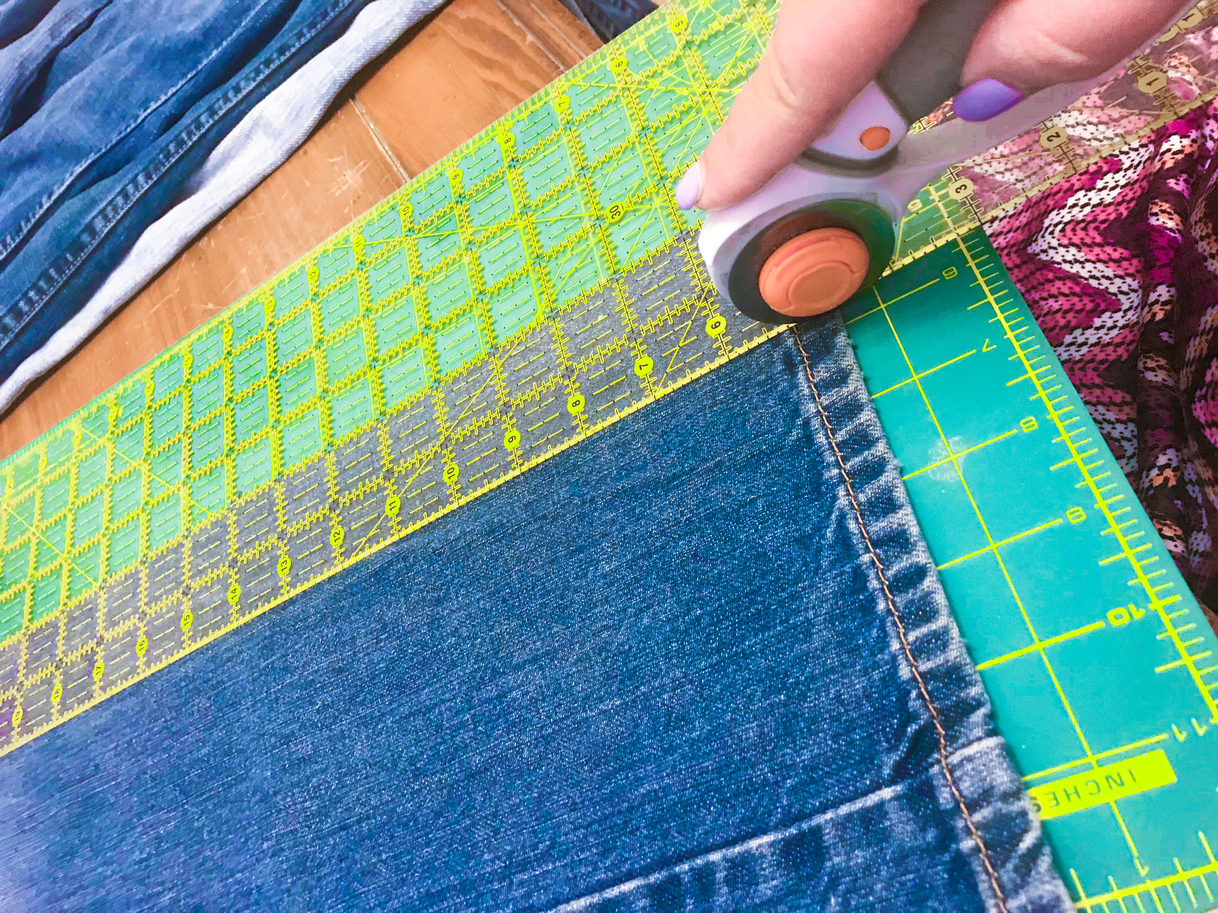 Cutting old jeans into strips using a rotary cutter. 