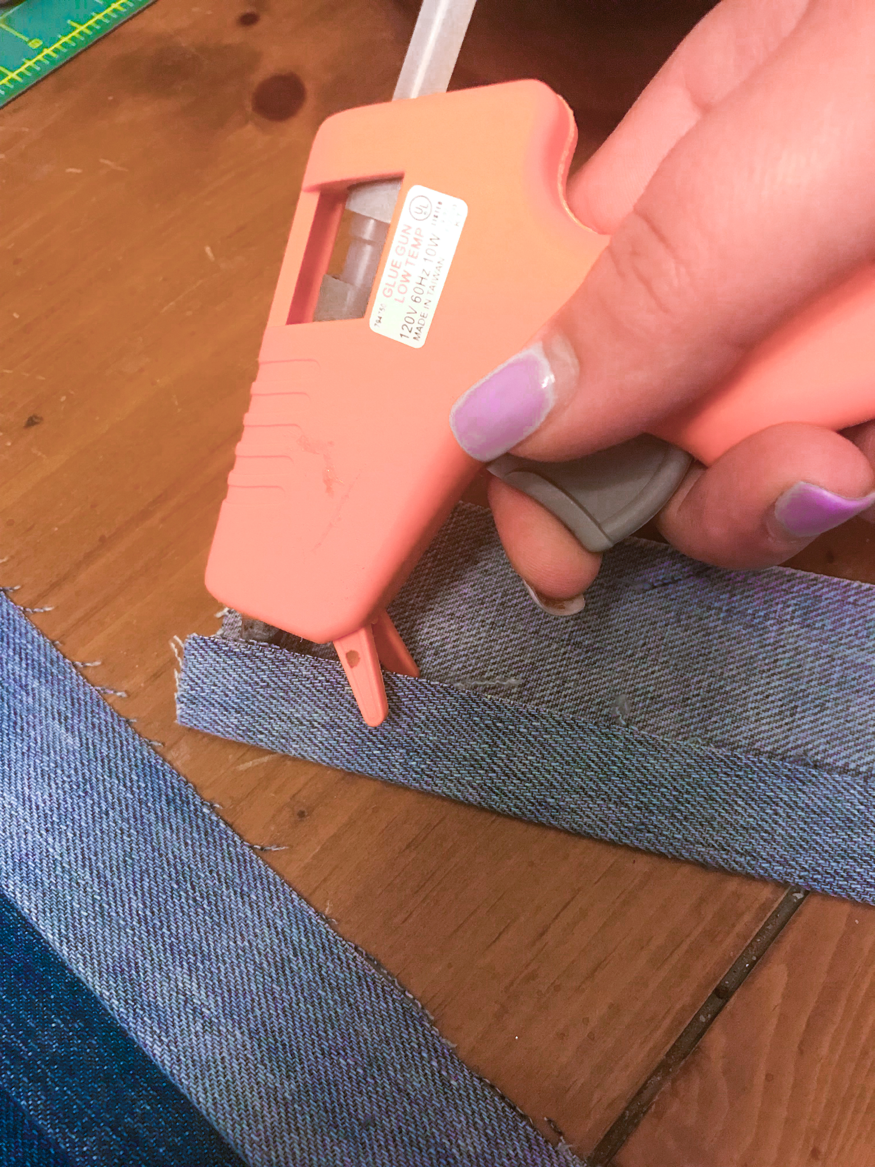 Gluing the inside lip of a jean crease.