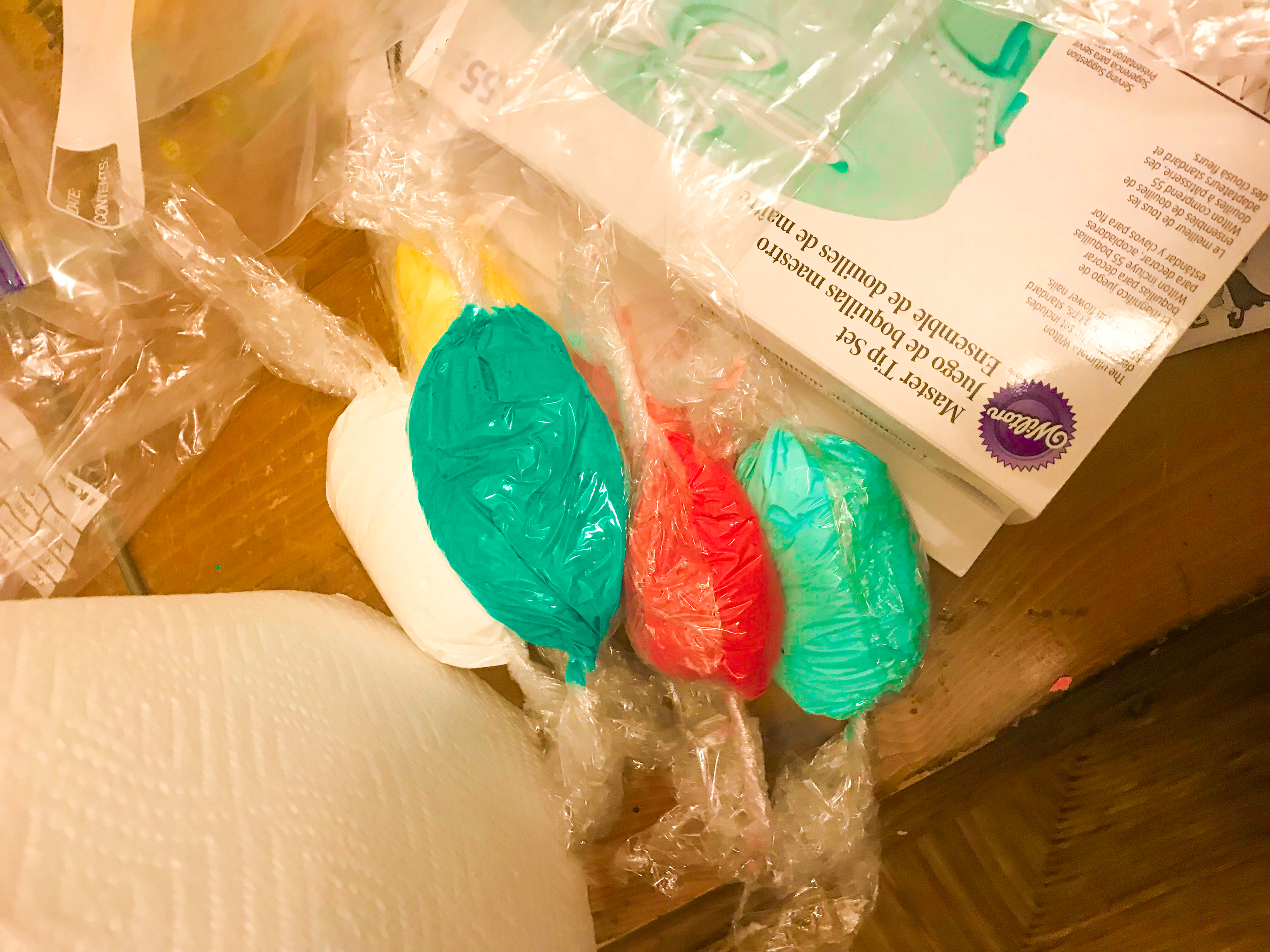 Colorful Royal icing wrapped in saran wrap 