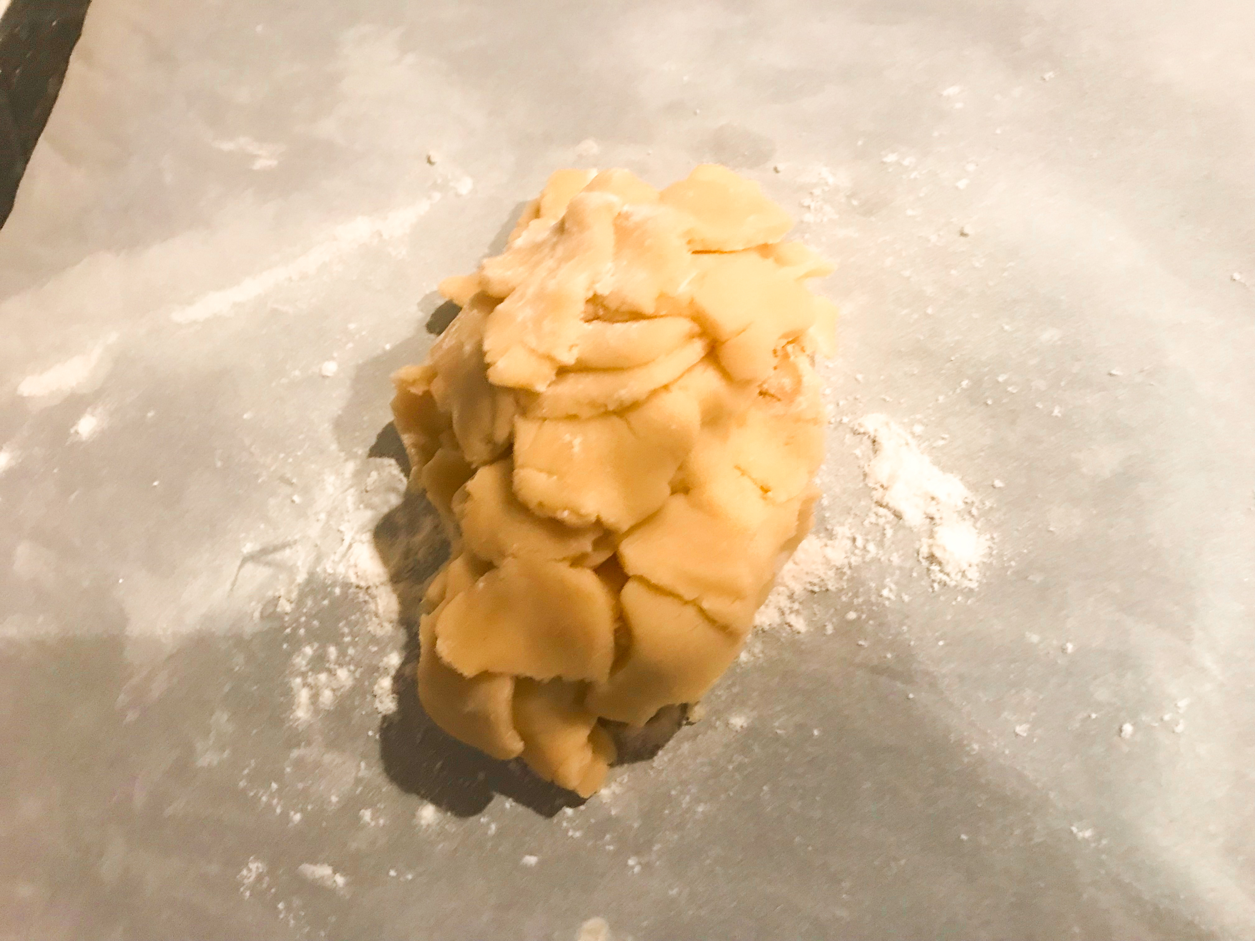 Sugar cookie dough scraps on parchment paper.