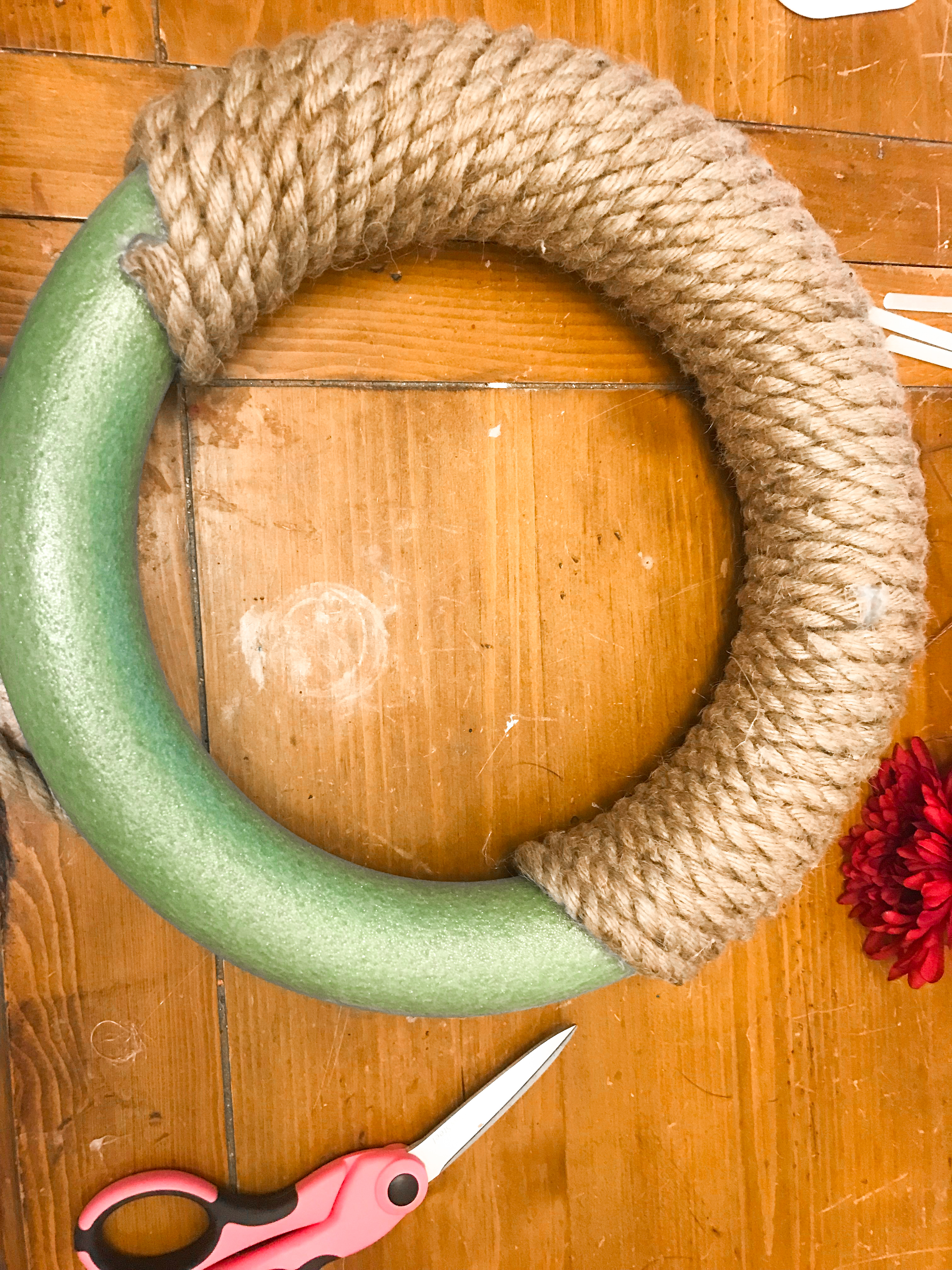 Wreath form wrapped in jute. 
