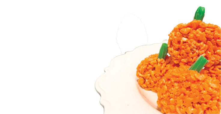 Pumpkin rice krispie treats on a white plate.