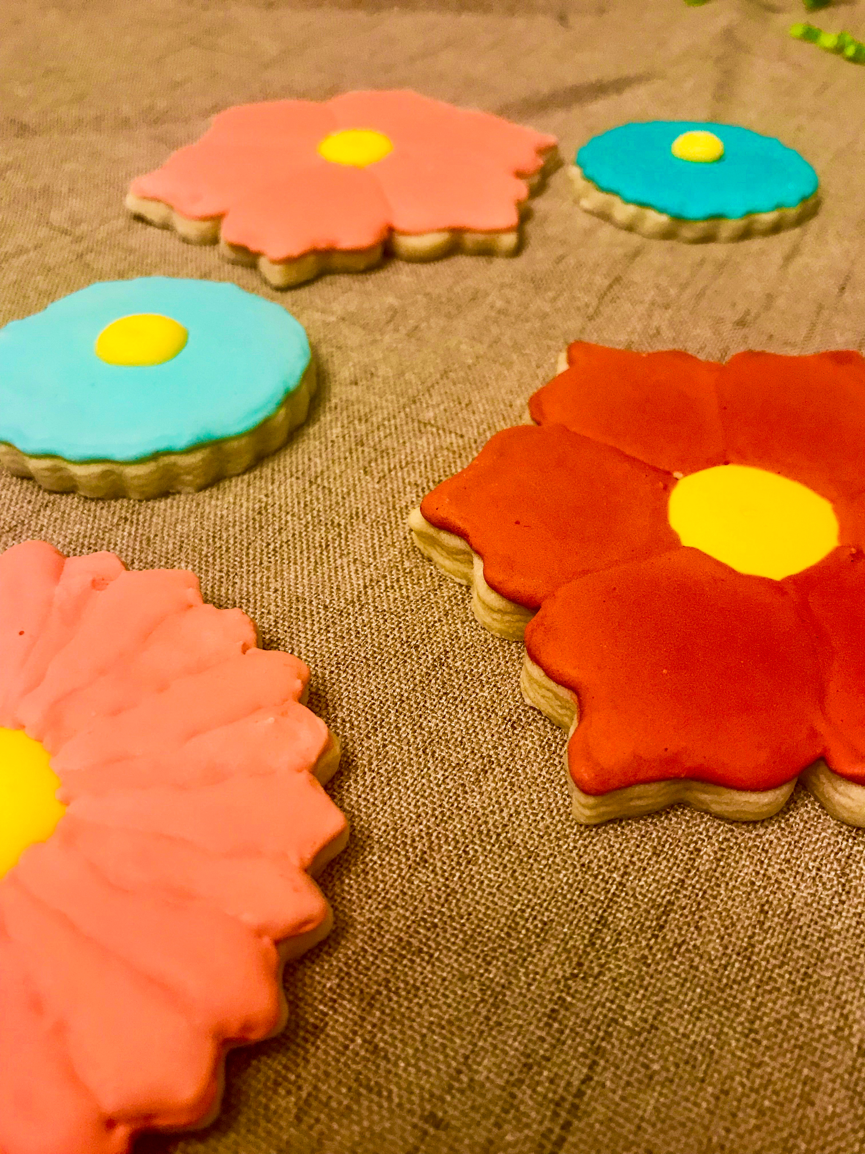 Colorful flower cookies on a fabric background