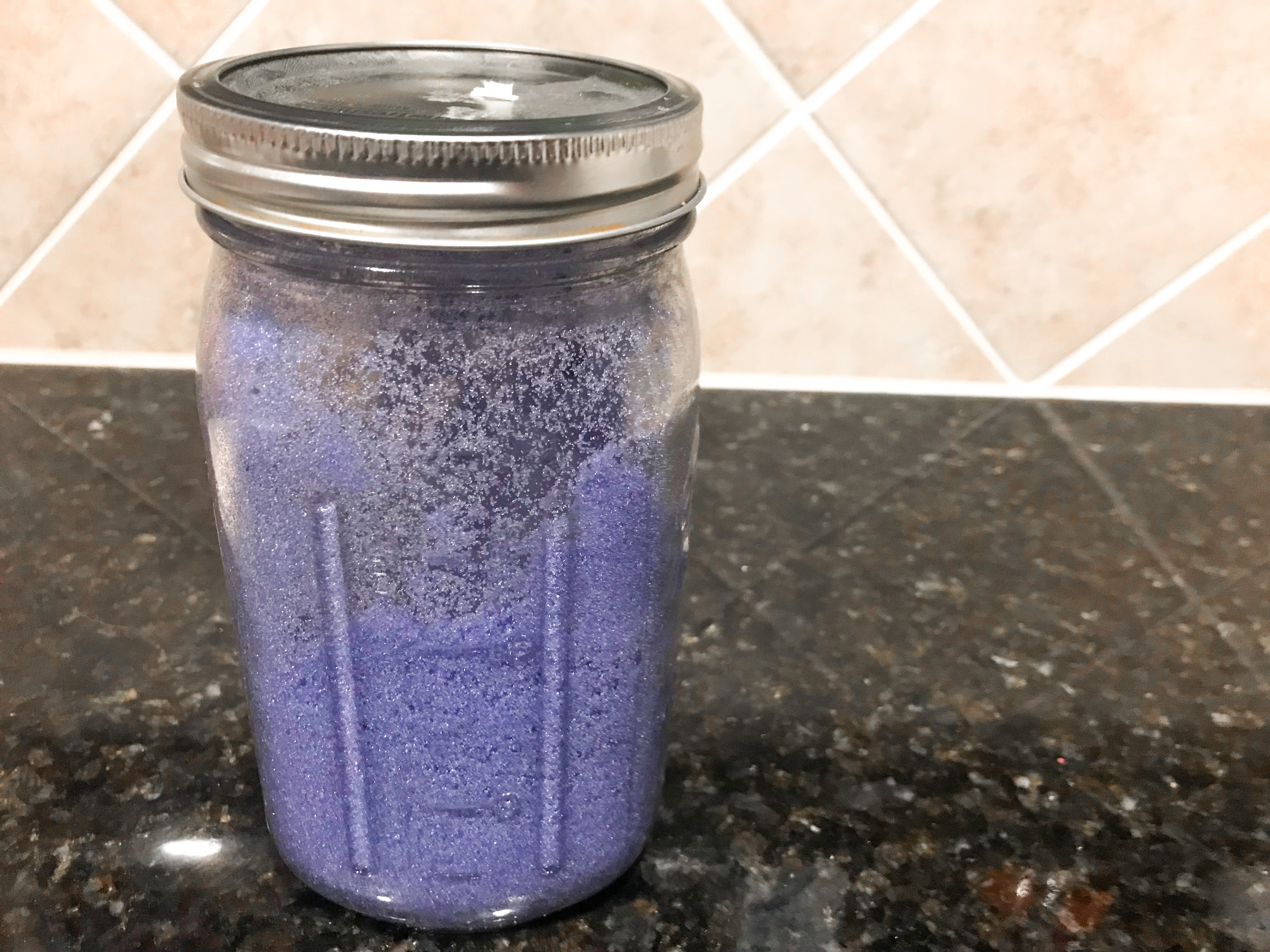 Vibrant purple sugar in a mason jar. 