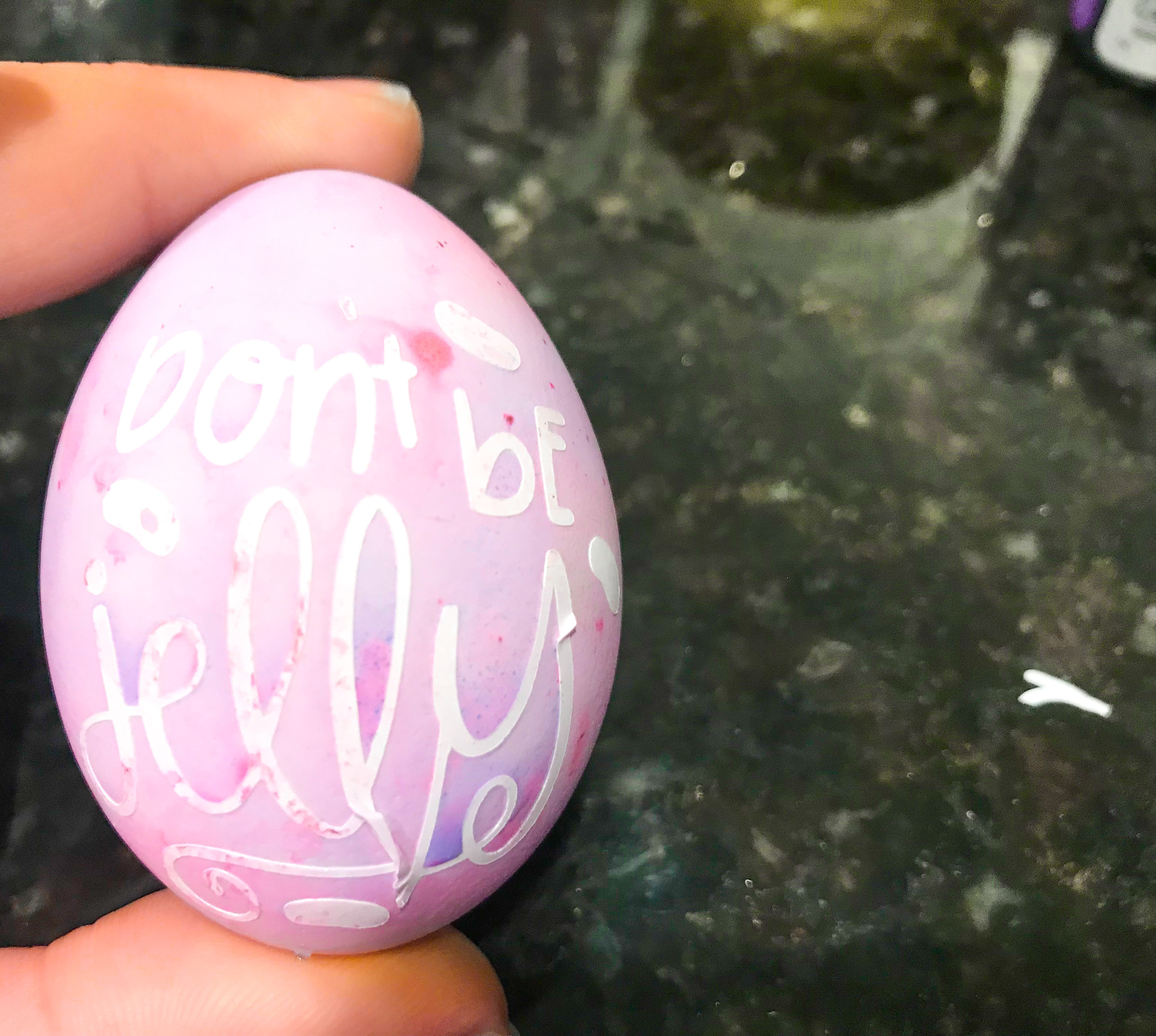 A vibrant easter egg which has had some of the vinyl peeled off.
