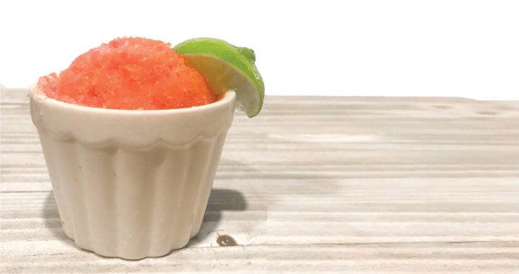 Icy watermelon sorbet with a slice of lime.
