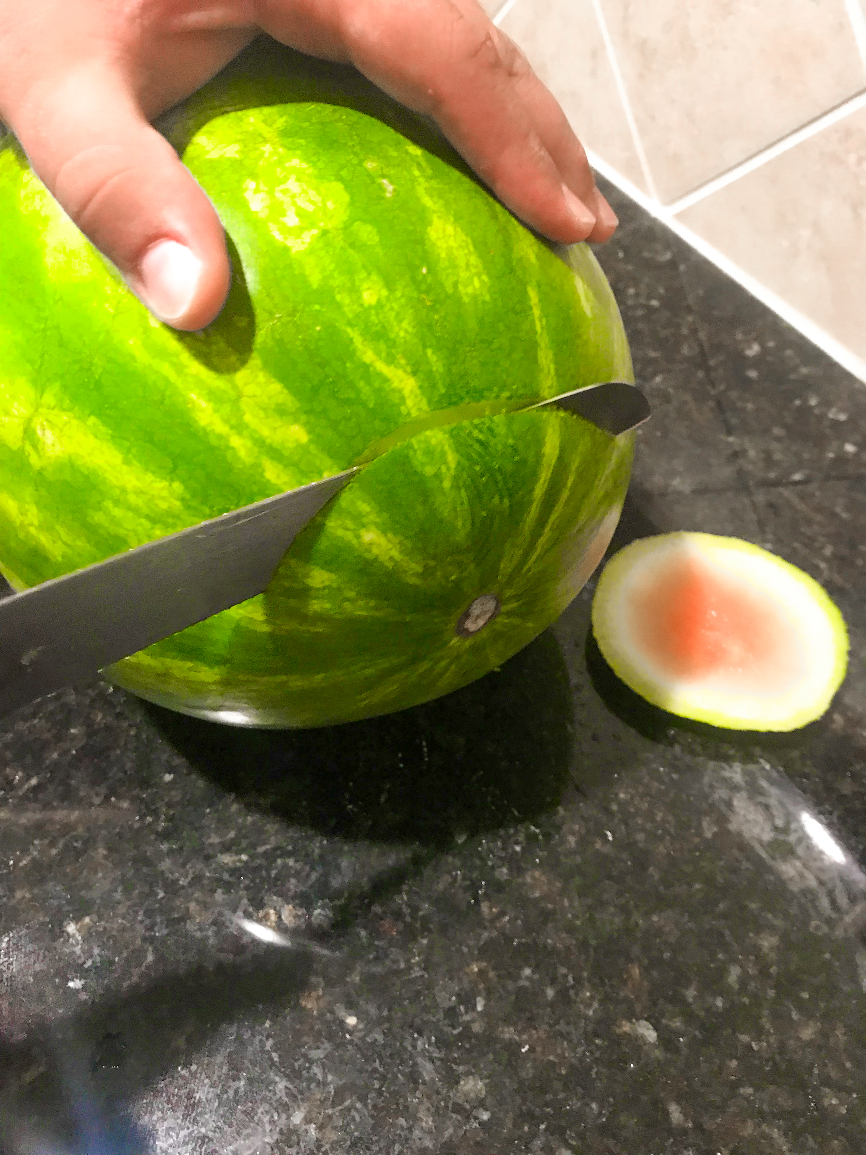 Cutting off the ends of a watermelon. 