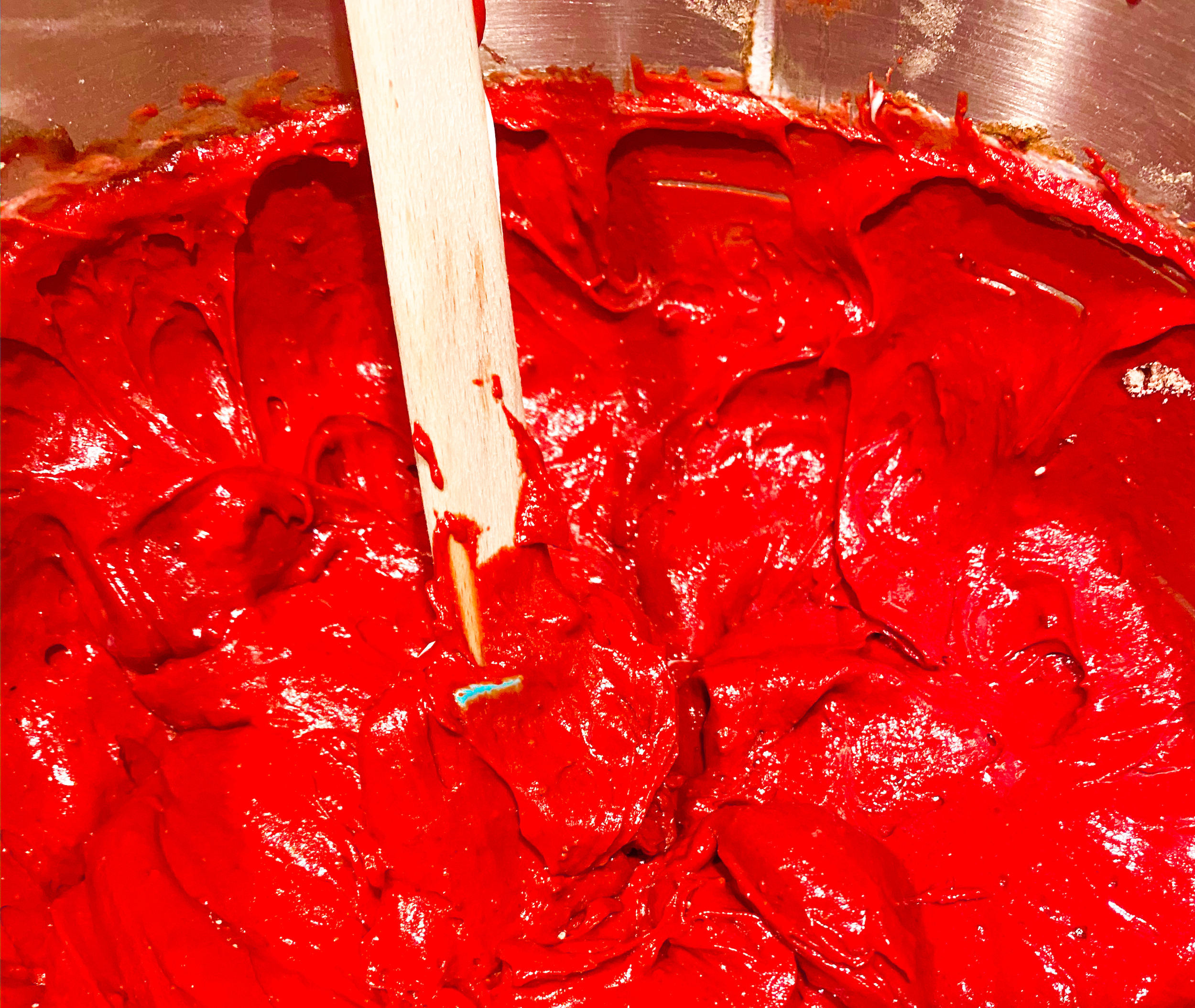 Red velvet bundt cake mix in a metal bowl. 